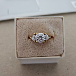 Three stone cubic zirconia and yellow gold-tone ring, size 5.